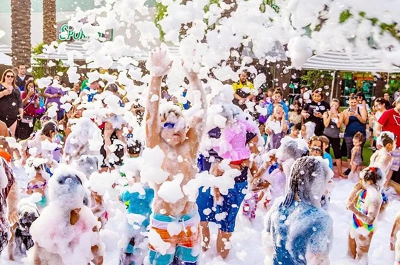 Crowd of kids and families enjoying an outdoor foam party event